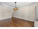Dining room featuring hardwood floors, neutral walls, and an elegant light fixture at 15210 Pavilion Valley Cir, Huntersville, NC 28078