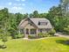 Beautiful brick home featuring well-manicured landscaping and a welcoming front porch at 15210 Pavilion Valley Cir, Huntersville, NC 28078