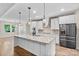 Modern kitchen featuring an island with granite countertops and stainless steel appliances at 15210 Pavilion Valley Cir, Huntersville, NC 28078