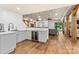 Stylish kitchen with white cabinets, wine cooler, hardwood floors and decorative wooden beams at 15210 Pavilion Valley Cir, Huntersville, NC 28078