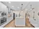 Modern kitchen with stainless steel appliances, granite countertops, a center island, and open staircase at 15210 Pavilion Valley Cir, Huntersville, NC 28078