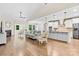 Open-concept living room with hardwood floors, a fireplace, and an island kitchen with stainless steel appliances at 15210 Pavilion Valley Cir, Huntersville, NC 28078