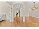 Open concept living space featuring hardwood floors, archways, and neutral paint at 15210 Pavilion Valley Cir, Huntersville, NC 28078