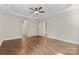 Spacious bedroom with tray ceilings and hardwood floors, showcasing ample natural light at 15210 Pavilion Valley Cir, Huntersville, NC 28078