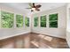Sun room with hardwood flooring and multiple large windows showcasing the natural view outside at 15210 Pavilion Valley Cir, Huntersville, NC 28078