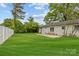 This beautiful backyard features a fenced in yard, well maintained grass, and an attached patio at 1601 Gambia St, Charlotte, NC 28208