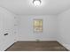 A bright bedroom features a window letting in natural light and hardwood flooring throughout the room at 1601 Gambia St, Charlotte, NC 28208