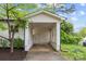 View of the carport with white support columns and decorative lattice at 1601 Gambia St, Charlotte, NC 28208