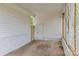 Carport interior featuring white walls, lattice accents, and a concrete floor at 1601 Gambia St, Charlotte, NC 28208