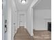 Open foyer with hardwood floors, white walls, and a view of the living room at 1601 Gambia St, Charlotte, NC 28208