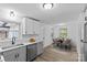 Eat-in kitchen area with white cabinets, stainless steel appliances, and wood-look flooring at 1601 Gambia St, Charlotte, NC 28208