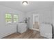 Spacious laundry room featuring washer, dryer, and a window for natural light at 1601 Gambia St, Charlotte, NC 28208