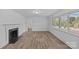 Spacious living room with hardwood floors, fireplace, and large windows for natural light at 1601 Gambia St, Charlotte, NC 28208