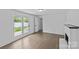 Bright living room features a brick fireplace, wood floors, and French doors to the backyard at 1601 Gambia St, Charlotte, NC 28208