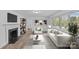 Bright living room with fireplace, hardwood floors, and natural light from large windows at 1601 Gambia St, Charlotte, NC 28208