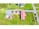 Aerial view of a property featuring a single-story home with a red roof, spacious lawn, and parking area at 161 Hickory Nut Dr, Statesville, NC 28677