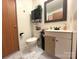 Functional bathroom featuring a toilet, sink, mirror, and storage shelves at 161 Hickory Nut Dr, Statesville, NC 28677
