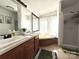 Bathroom with dual sinks, large mirrors, tub and walk in shower at 161 Hickory Nut Dr, Statesville, NC 28677