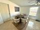 Bright dining area with a wooden table surrounded by four white chairs next to a window at 161 Hickory Nut Dr, Statesville, NC 28677