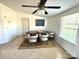Bright dining area with a modern ceiling fan and a wooden table surrounded by four white chairs at 161 Hickory Nut Dr, Statesville, NC 28677