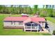 Charming single-story home featuring red roof and cozy front porch, surrounded by a lush green lawn at 161 Hickory Nut Dr, Statesville, NC 28677