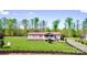 Single-story home featuring a red roof and inviting front porch, set within a vast, well-manicured lawn at 161 Hickory Nut Dr, Statesville, NC 28677