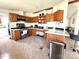 Spacious kitchen with wooden cabinets, stainless steel appliances, and an island with counter seating at 161 Hickory Nut Dr, Statesville, NC 28677