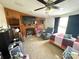Casual living area features a ceiling fan, fireplace, TV, and an adjacent bedroom area at 161 Hickory Nut Dr, Statesville, NC 28677