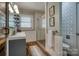 Well-lit bathroom showcases a glass shower, wood-look tile, and gray vanity with shelving at 1680 Ne 17Th Avenue Ct, Hickory, NC 28601