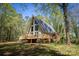 Charming A-frame home with a spacious wraparound deck surrounded by lush greenery at 1680 Ne 17Th Avenue Ct, Hickory, NC 28601