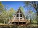 Lovely A-frame home featuring a large wooden deck, surrounded by lush trees at 1680 Ne 17Th Avenue Ct, Hickory, NC 28601