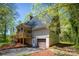Home exterior featuring a garage, covered porch, and lush landscaping at 1680 Ne 17Th Avenue Ct, Hickory, NC 28601