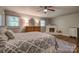 Bright main bedroom with fireplace, dresser, and ceiling fan at 1680 Ne 17Th Avenue Ct, Hickory, NC 28601