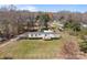 Aerial view of a single-story home with a spacious green lawn and additional storage buildings at 189 Woodwinds Dr, Mooresville, NC 28115