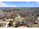 Expansive aerial view of a rural property with home surrounded by trees and open fields at 189 Woodwinds Dr, Mooresville, NC 28115