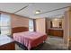 A bedroom features two windows, pink walls, and an attached bathroom at 189 Woodwinds Dr, Mooresville, NC 28115