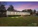 Charming single-story home featuring red shutters, a cozy front porch, and a spacious, green front yard at 189 Woodwinds Dr, Mooresville, NC 28115