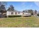 Charming single-story home featuring red shutters, a cozy front porch, and a spacious, green front yard at 189 Woodwinds Dr, Mooresville, NC 28115