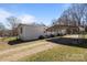 This home's exterior boasts a large metal carport and a driveway for easy parking plus some small bushes at 189 Woodwinds Dr, Mooresville, NC 28115