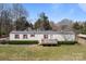 Single-story home with red shutters, a front porch, and a spacious, green front lawn at 189 Woodwinds Dr, Mooresville, NC 28115