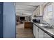 An open kitchen boasts granite countertops, tile backsplash, and seamlessly connects to the living area at 189 Woodwinds Dr, Mooresville, NC 28115