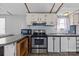 A kitchen features stainless steel appliances, granite countertops, and a breakfast bar at 189 Woodwinds Dr, Mooresville, NC 28115