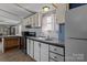 A kitchen features granite countertops, a tile backsplash, and white cabinets at 189 Woodwinds Dr, Mooresville, NC 28115