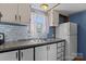 A kitchen features granite countertops, a tile backsplash, and white cabinets at 189 Woodwinds Dr, Mooresville, NC 28115