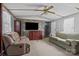 A cozy living room features two sofas, a ceiling fan and a decorative fireplace at 189 Woodwinds Dr, Mooresville, NC 28115