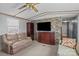 Living room with a decorative stone wall, comfortable seating, and a ceiling fan at 189 Woodwinds Dr, Mooresville, NC 28115