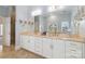 Bathroom features a large mirror over double sinks, bright lighting, and tile flooring at 1921 Brandon Cir, Charlotte, NC 28211
