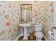 Charming powder room featuring floral wallpaper, an ornate mirror, and pedestal sink at 1921 Brandon Cir, Charlotte, NC 28211