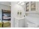 Bright bathroom with white vanity, cabinet storage, and a view to a bunk room at 1921 Brandon Cir, Charlotte, NC 28211