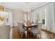 Formal dining room featuring a chandelier, hardwood floors, and large windows for ample natural light at 1921 Brandon Cir, Charlotte, NC 28211